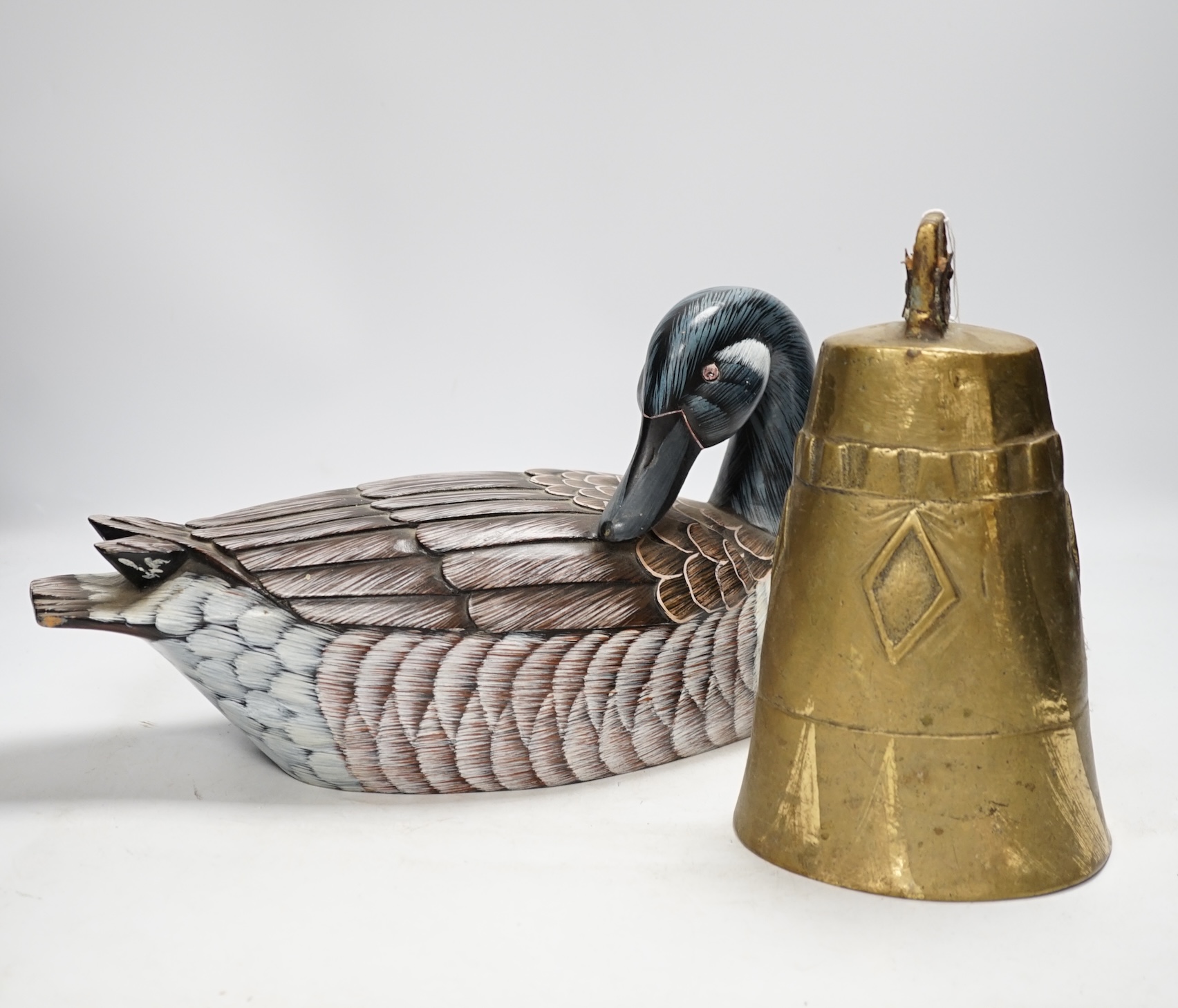 A Chinese carved wood duck and a brass bell, bell 25cm high. Condition - fair